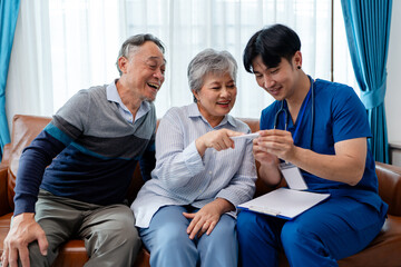 asian senior couple consult and discuss medical examination results with physiotherapist at clinic....