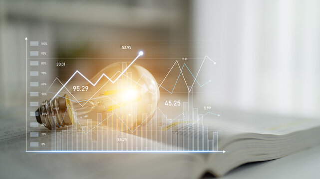 A creative representation of a light bulb lying on an open book with overlaid business analytics graphs, highlighting concepts of innovation and strategic growth. Scalp - Powered by Adobe
