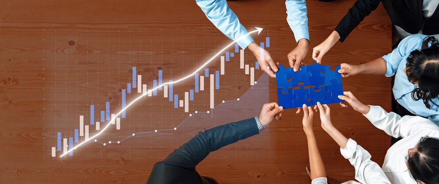A diverse team collaborates over a business analysis chart, integrating puzzle pieces symbolizing innovation and strategy enhancement for achieving success. Axiom