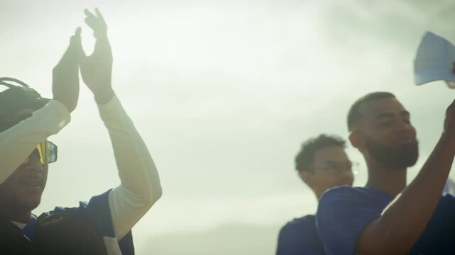 Baseball team celebrates a hard-fought victory. Players clap and cheer, displaying joy and unity after a successful game. The catcher shares in the triumph.