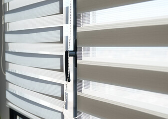 Modern striped window blinds with soft daylight filtering through fabric layers