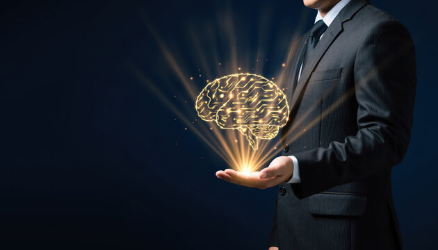 Professional businessman in suit holds glowing brain symbolizing intelligence and innovation, radiating light against dark background. image conveys creativity and technology