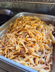 Soft tagliatelle coated evenly with savory sauce.
