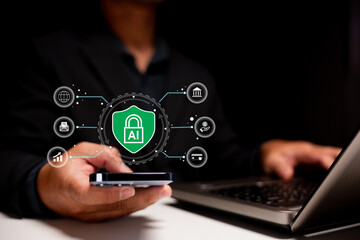 A person holds a smartphone, surrounded by icons representing AI and cybersecurity, while using a laptop in a dark environment.