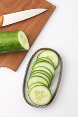   sliced cucumbers arranged on a small oval plate