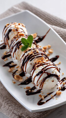 Delicious ice cream rolls drizzled with chocolate sauce and sprinkled with crushed peanuts, garnished with fresh mint leaves