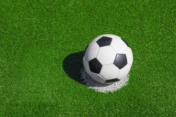 green grass texture with a soccer ball - well-groomed turf in the garden