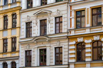 Historic Wrocław townhouse featuring ornate façade decorations, classical architectural detailing and symmetrical window arrangement across its exterior façade