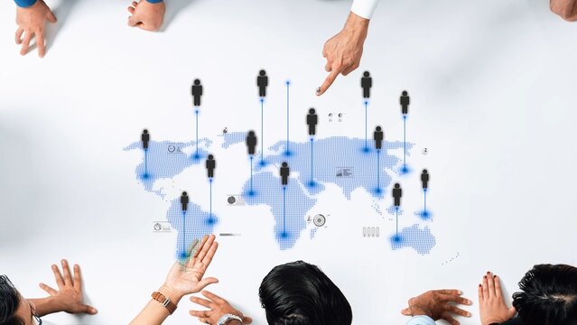 A diverse team collaborates over a virtual map, symbolizing global connections and networks. The image showcases hands and people icons representing teamwork and strategy. Raster