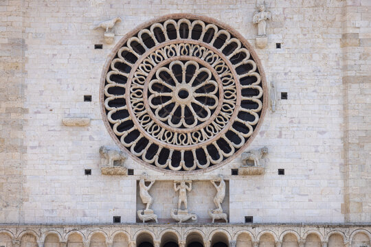 Decorative facade with rose window of romanesque 12th century Assisi Cathedral, Assisi, Italy