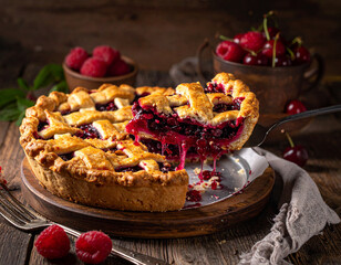 Slice of berry pie lifted with a cake server, filling oozing