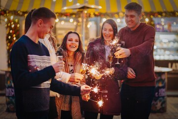 Group funny people winter holidays. Christmas concept with firework sparkler
