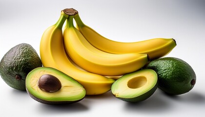 vibrant yellow bananas and dark green avocados one halved arranged artfully against a stark white backdrop