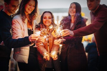 Group funny people winter holidays. Christmas concept with firework sparkler