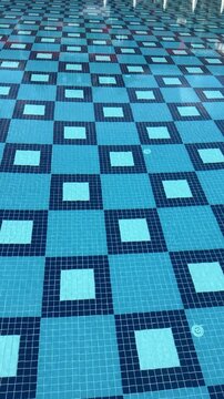 Blue ceramic pool tile with smooth, glossy surface, sized 240x115x9 mm, ideal for lining pool floors and walls. Durable, easy to clean, and prevents dirt buildup