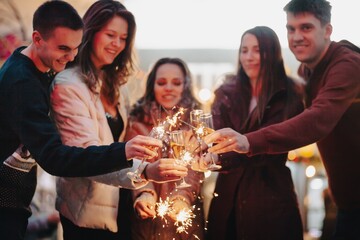 Group funny people winter holidays. Christmas concept with firework sparkler