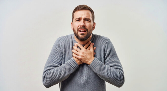 Distressed man clutching his chest due to sudden shortness of breath or asthma attack. Concept of health emergency and respiratory pain