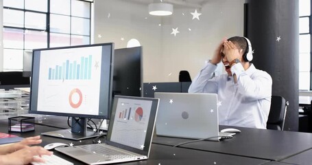 Man hearing laptop and cheering removing headset leaving office as woman typing charts under stars