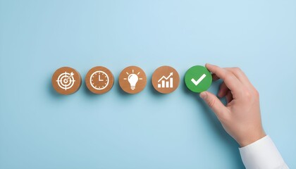 Hand placing a green check mark among business icons on wooden discs.