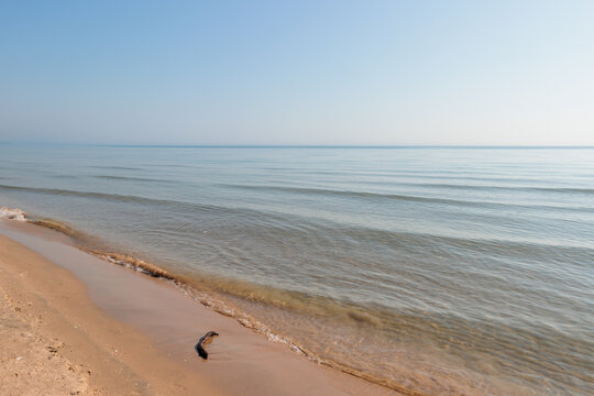 The monring haze is slowly disappearing over Lake Michigan at Harrington Beach State Park, Belgium, Wisconsin in mid-August