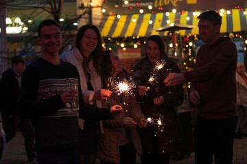 Group funny people winter holidays. Christmas concept with firework sparkler