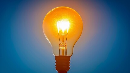 Illuminated Incandescent Light Bulb Displaying Classic Lighting Principles in a Vintage Setting.