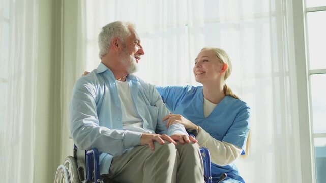 Help support retirement healthcare. Nurse helping old man in wheelchair. Patient and woman in nursing home for medical caregiver. Nurse taking care of paralyzed man in chair for people with disability