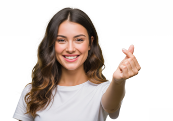 Young attractive woman with long wavy brown hair smiling and making a heart shape gesture with her fingers isolated on transparent background