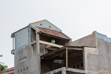 Abandoned old unfinished building facade. Abandoned two story residential building.