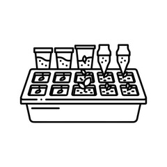 Seedling tray with small plants and gardening tools for planting