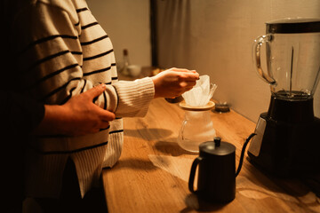 Young Woman Pouring Coffee in Filter Bag her Man Hugging Behind, Close-Up