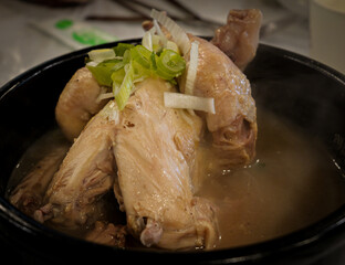 Steaming Samgyetang Ginseng Chicken Soup in Black Bowl