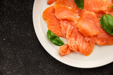 Smoked salmon fish seafood portion size natural product tasty snack fresh delicious gourmet food background on the table rustic top view copy space pescetarian diet