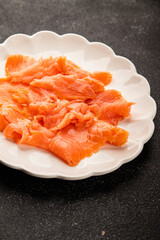 Smoked salmon fish seafood portion size natural product tasty snack fresh delicious gourmet food background on the table rustic top view copy space pescetarian diet