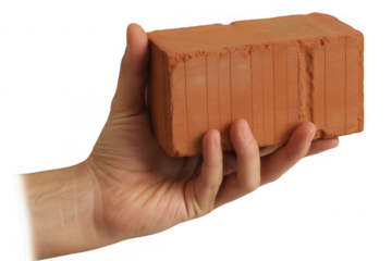 Hand holding red brick with vertical grooves isolated on a transparent background