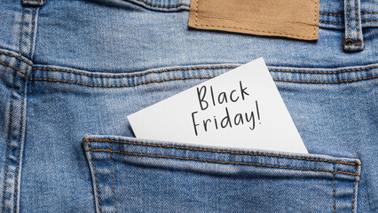 Readiness for Shopping: Reminder of "Black Friday!" On a note protruding from the back pocket of light blue jeans, symbolizing the season of sales and discounts.