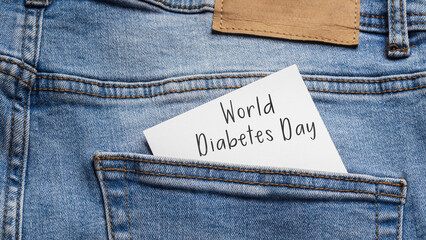 Diabetes Awareness: A white note with the inscription "World Diabetes Day" inserted into the back pocket of light jeans, symbolizing health and memory