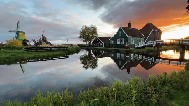 traditional Dutch village Zaanse Schans over water at summer sunset, Netherlands
