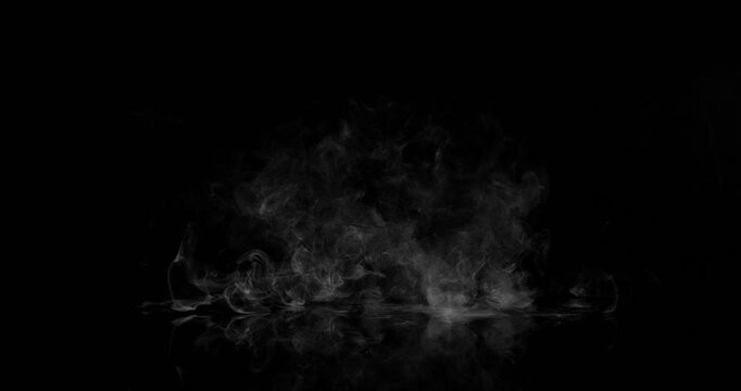 Super Slow Motion of White Surface Smoke Texture Isolated on Black Background. Filmed on High Speed Cinema Camera, 500fps. VFX element for overlay.