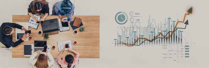 A diverse team of professionals collaborates around a meeting table, analyzing data charts and metrics to strategize for improved business performance and growth. Scalp
