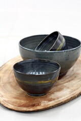 Beautiful Japanese ceramics on a wooden base on the table.