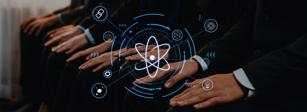 Hands of a business team rest on their laps, surrounded by digital atomic icons, symbolizing collaboration in technology and scientific advancement in the modern workplace. Trope - Powered by Adobe