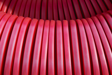 Bright Red Corrugated Plastic Cable Conduit Close-up
