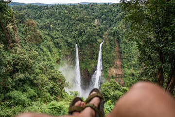Person relaxing enjoying Tad fane waterfall view in laos