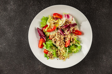 Quinoa salad tomato, green leaf salad vegetables dish natural product tasty snack fresh gourmet food background on the table rustic top view copy space keto and paleo diet vegan and vegan food