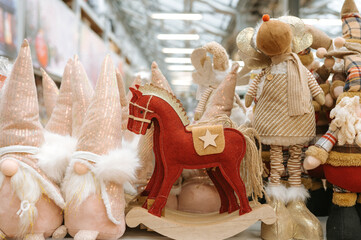 Festive christmas decorations with plush gnomes and red rocking horse