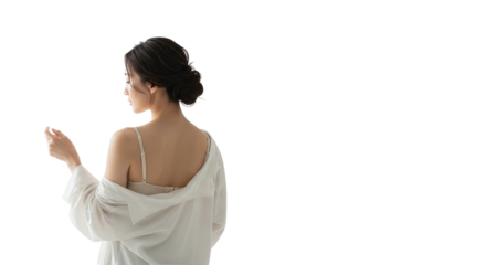 A young woman with dark hair styled up, seen from behind, wearing a white shirt off her shoulders and a bra strap, looking over her shoulder, isolated on transparent background
