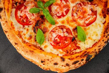 Pizza tomato margarita fast food natural product tasty snack fresh delicious gourmet food background on the table rustic top view copy space