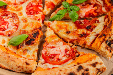 Pizza tomato margarita fast food natural product tasty snack fresh delicious gourmet food background on the table rustic top view copy space