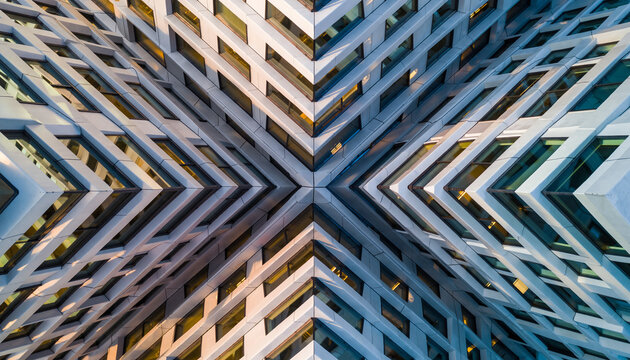 Stunning symmetrical building facade with intricate window patterns creating a modern architectural marvel for innovative design and urban development projects - Powered by Adobe
